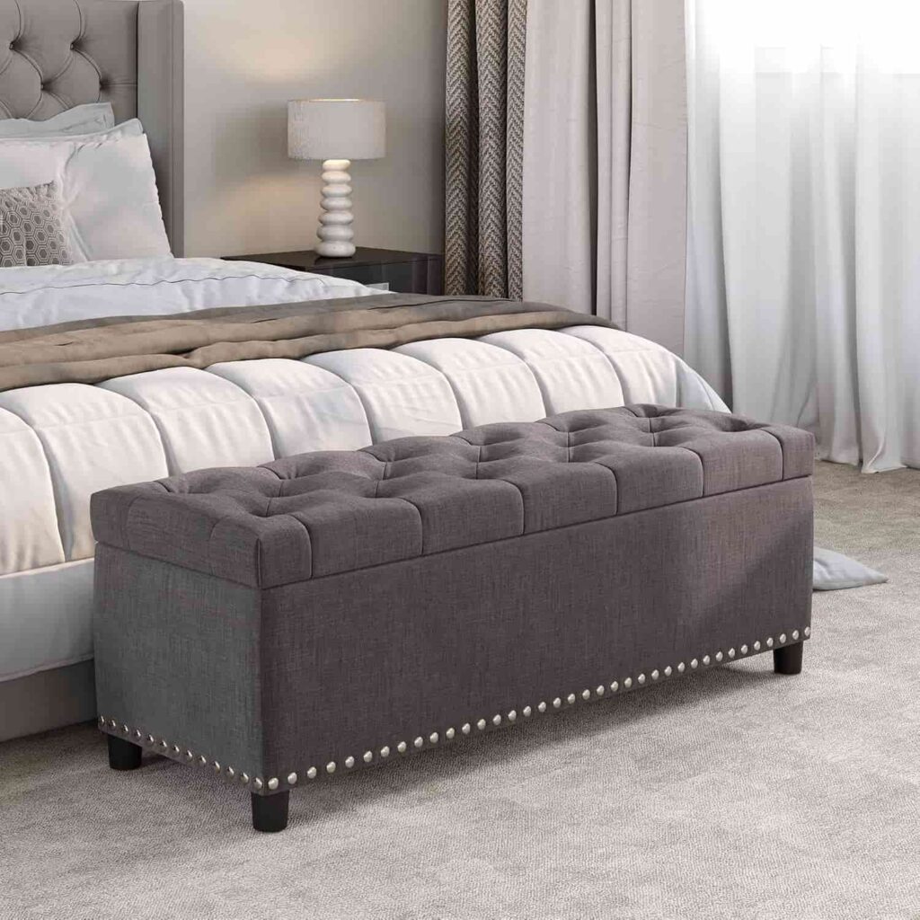 BELLEZE 47 inch storage ottoman bench in dark grey at the foot of a bed